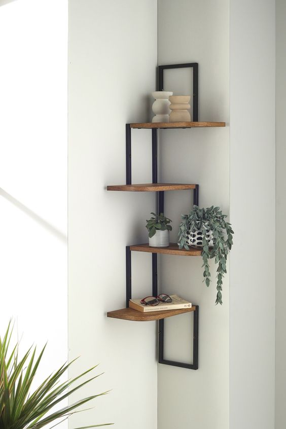 an industrial shelving unit of metal and wood, with decor and potted plants is a smart solution for any corner