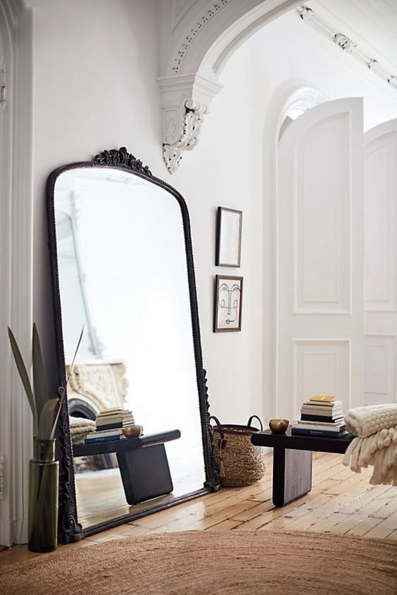 an oversized mirror placed in any random nook adds light and visually enlarges the space making it cooler