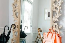 design a chic entryway with a mirror in a wood carved frame that will make a statement in the space