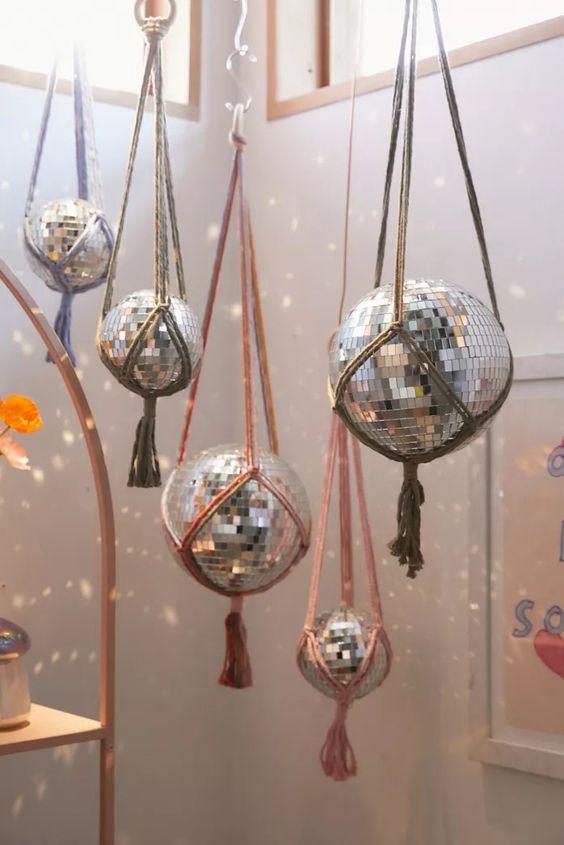 Hang disco balls using usual yarn to make your space more boho like, add tassels or fringe to them
