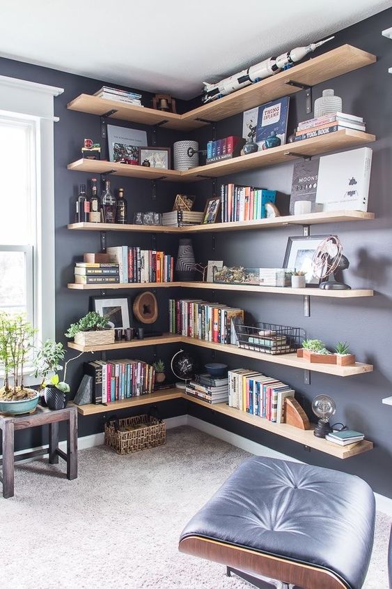 large corner shelves from floor to ceiling add interest to the space and accommodate and display a lot of chic stuff