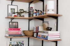 large wall-mounted shelves holding various decor, books, lamps and other stuff will make use of a small nook
