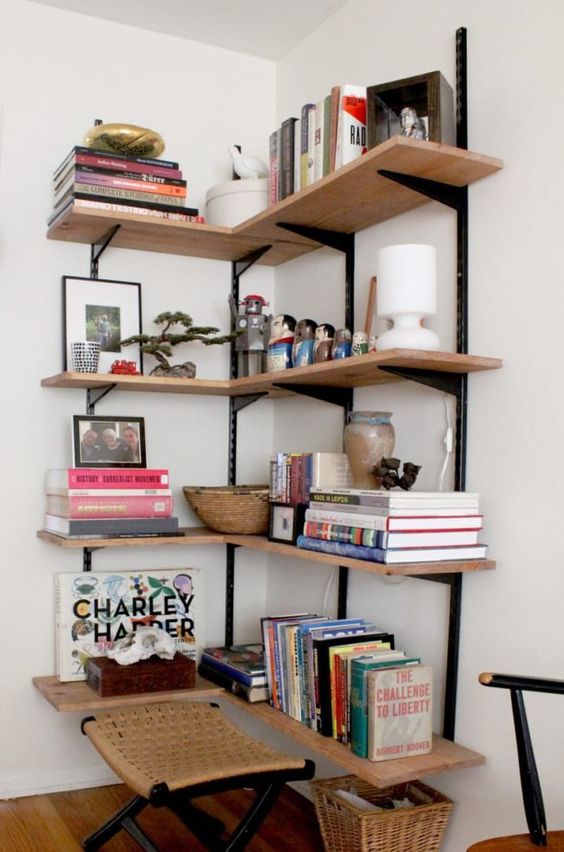 Large wall mounted shelves holding various decor, books, lamps and other stuff will make use of a small nook