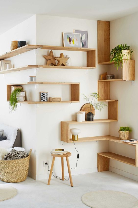 Light stained open and box corner shelves as a whole system with decor, potted plants, are great for a contemporary space