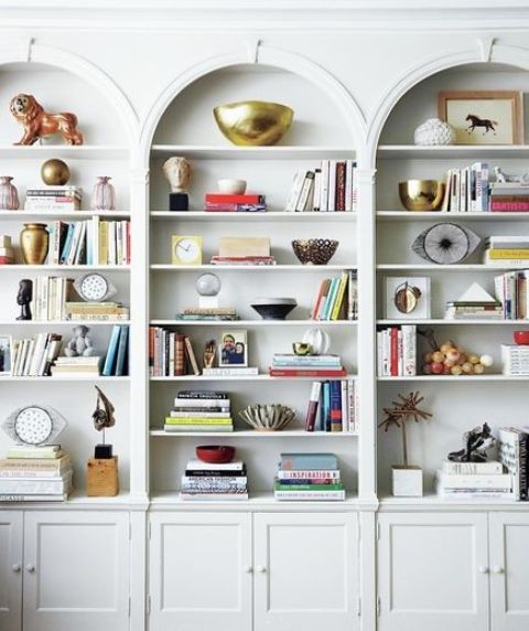 off-white arched built-in bookcases are a cool idea for any room, they will provide storage space and let you display some decor