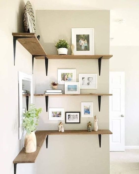 simple corner shelves with photos, artwork, a plate, greenery and some decorations are great