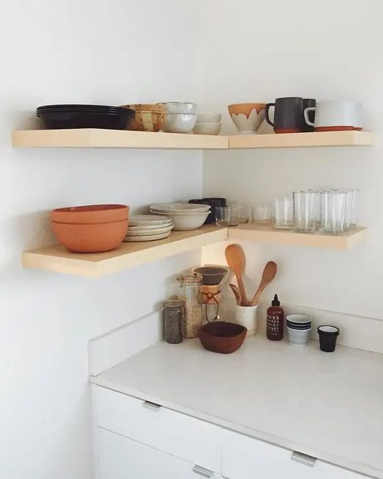 simple wooden floating shelves in the corner will add functionality to the space and will bring a warm touch with wood
