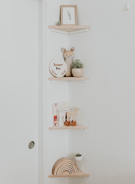 small and pretty corner shelves with decor, potted plants, kids' books are lovely for a neutral nursery or kids' room