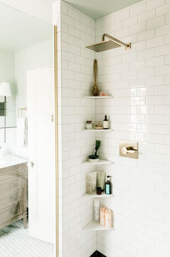 tiny corner shelves will literally save your life in a tiny shower space accommodating everything you need