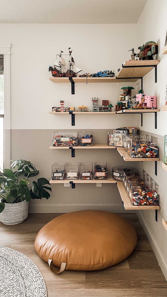 Wall mounted corner shelves with toys and containers for Lego are an optimal idea for a kids' playroom
