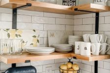 wall-mounted stained corner shelves with glasses and teaware are a perfect idea for a farmhouse space