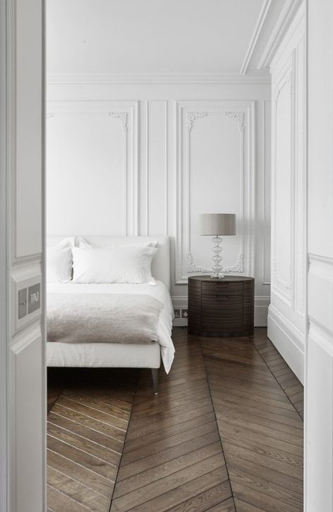white paneling makes the bedroom super refined and chic at once, just add some furniture to this backdrop