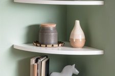 white rounded corner shelves with books, vases and potted plants are a cool solution for a Scandinavian space