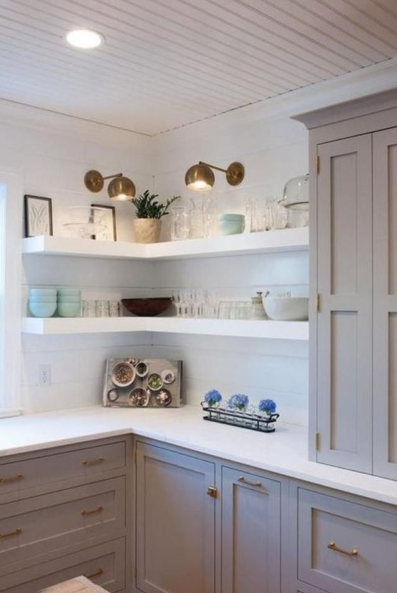 white thick corner shelves with additional spotlights are great to save some space in the kitchen