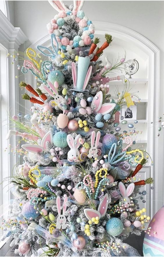 a Christmas tree styled for Easter with bunnies, bunny ears, carrots, beads and some pastel baubles is amazing