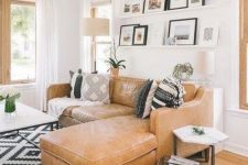 a cute living room with a ledge gallery wall