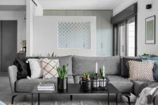 a neutral Scandi living room with a grey sofa