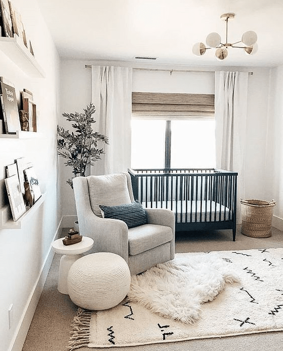 a chic modern nursery with a farmhouse twist, with all-neutrals, a black crib, a basket for storage and ledges with books