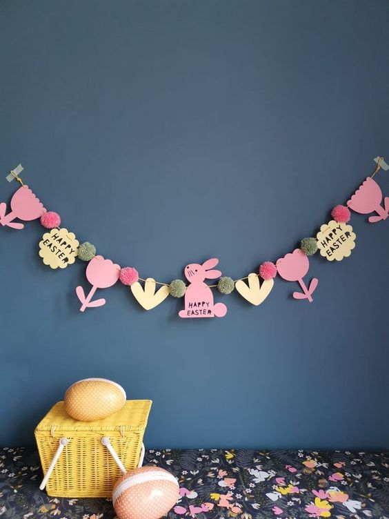 a colorful Easter garland of bunnies, flowers, leaves and pompoms is a cool decoration to make