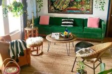 a colorful maximalist living room with boho touches, bright textiles, potted greenery and wicker furniture