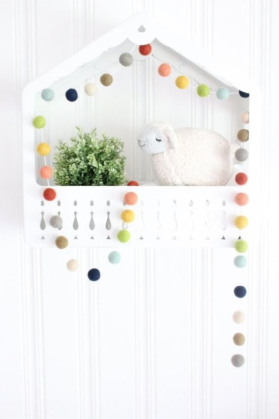a colorful pompom garland like this one will be a nice idea for spring and summer decor