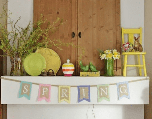 a colorful spring mantel with a bright burlap bunting, colorful plates, faux birds and bunnies
