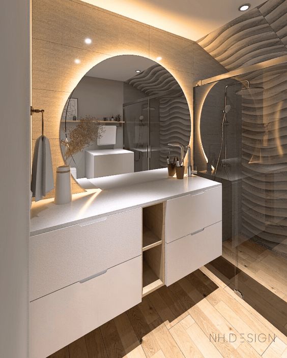 a contemporary bathroom with a large white vanity built of IKEA Metod, a round mirror with light and a shower space