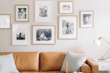 a simple yet cute living room with a gallery wall behind a sofa