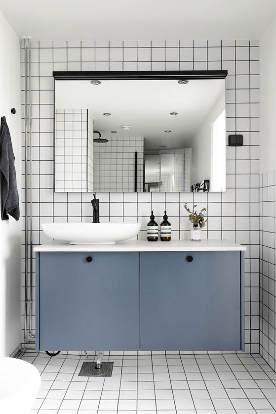 a floating bathroom vanity of an IKEA Metod cabinet with petrol blue paint and knobs is a stylish piece you can DIY