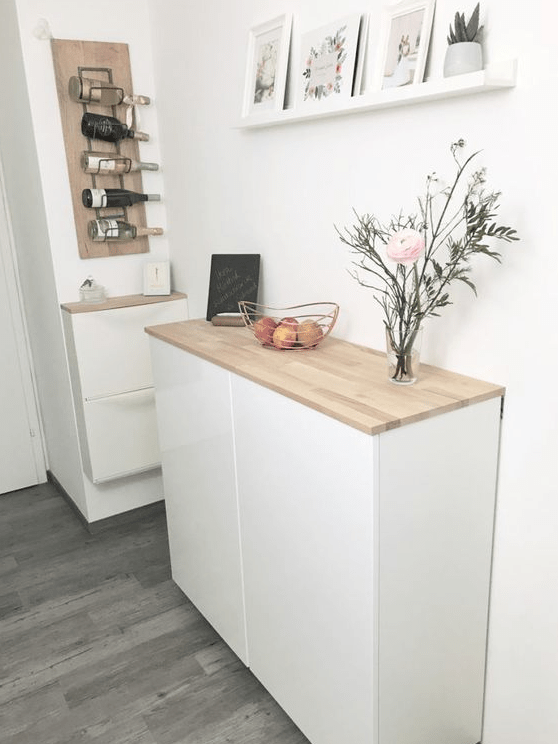 a floating sideboard of an IKEA Metod cabinet and a matching hack for an IKEA Trones piece are a great combo for a Scandinavian entryway