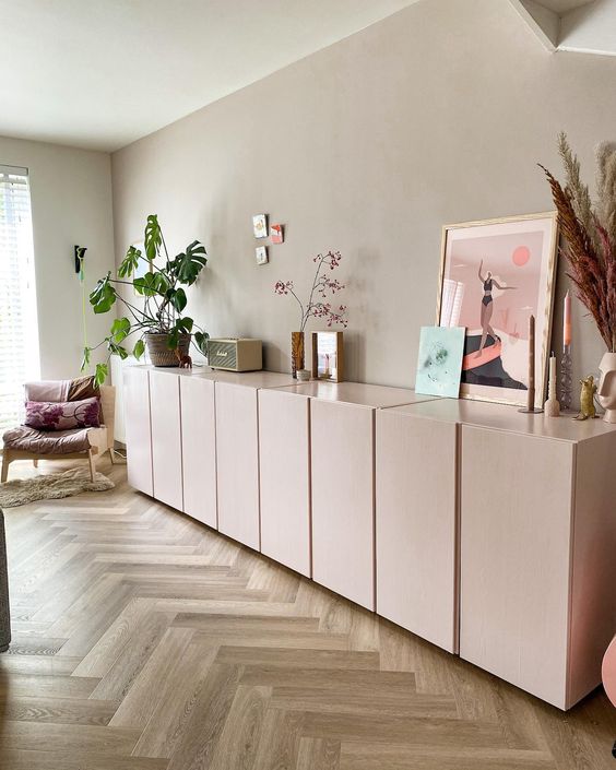 a large light pink sideboard composed of IKEA Metod cabinets, with beautiful decor and potted plants