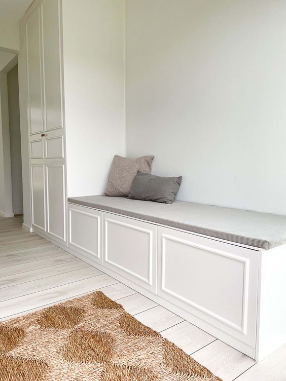 a large storage unit of a wardrobe and storage bench, the bench is built of IKEA Metod pieces