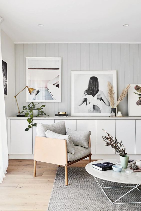 a large white sideboard composed of IKEA Metod cabinets, with large artwork, greenery, pampas grass and a gold table lamp