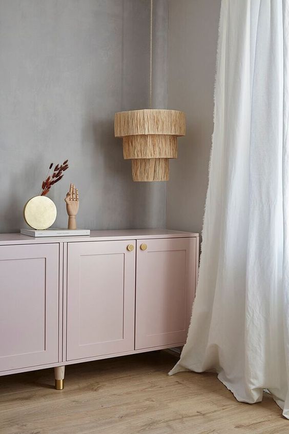 a light pink credenza of IKEA Metod cabinets, with shaker doors, gold knobs and legs is pure chic