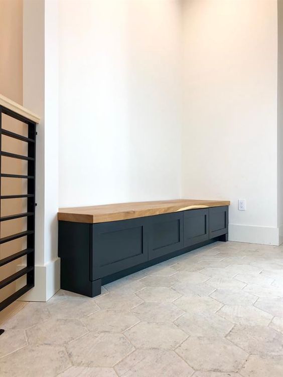 a long black storage bench of IKEA Metod cabinets with a butcherblock countertop is great for a modern space