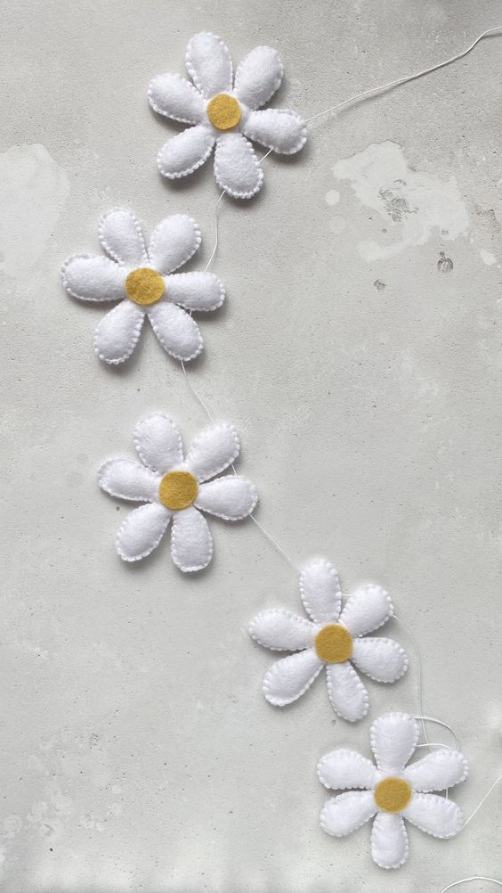 a lovely white felt flower garland is a cool idea for spring and summer, and it can be DIYed