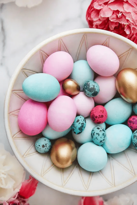 a modern Easter arrangement of turquoise, pink, hot pink and gold eggs of various sizes is a cool idea for the holidays