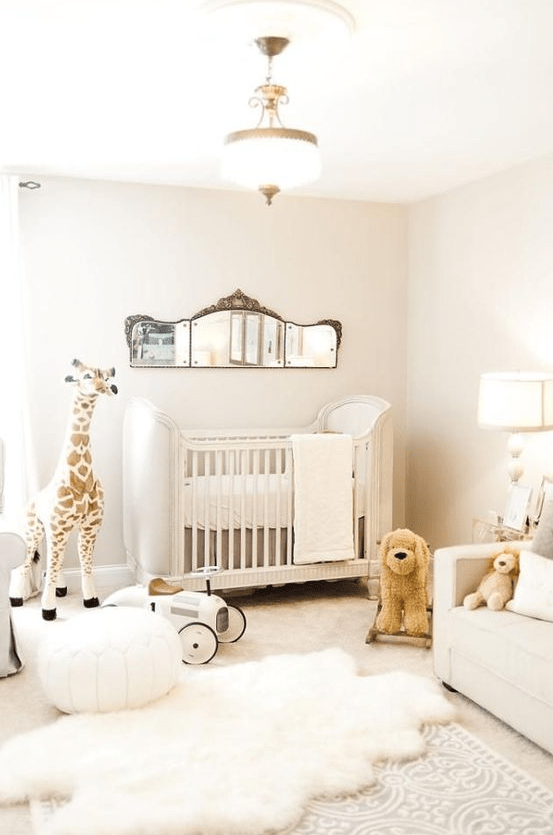 a neutral contemporary nursery with a catchy crib, a creamy sofa, layered rugs, toys, a vintage mirror and some lamps