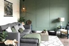 a lovely living room with a green accent wall