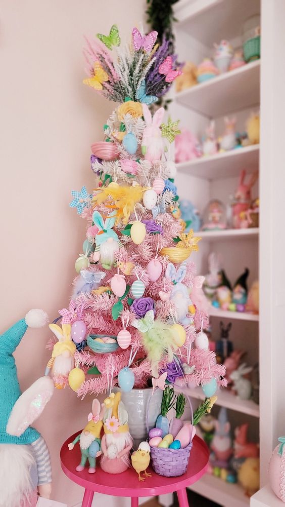 a pastel Christmas tree with pastel faux eggs, blooms and little bunnies and butterflies are amazing for Easter