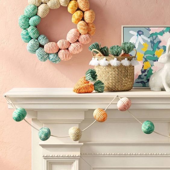 a pastel garland of yarn covered eggs  and a matching wreath are a cool combo for spring decor