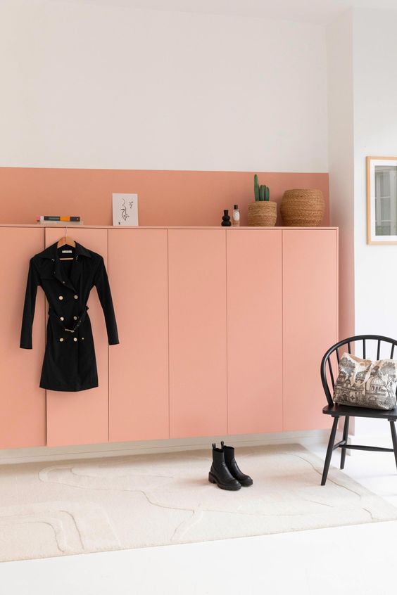 a peachy pink floating wardrobe of IKEA Metod units, with decor and books on top looks gorgeous