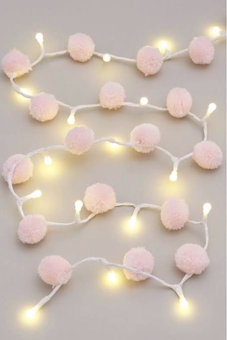 a pink pompom and light garland is a cool idea for spring, the tender color will remind of spring pastel blooms