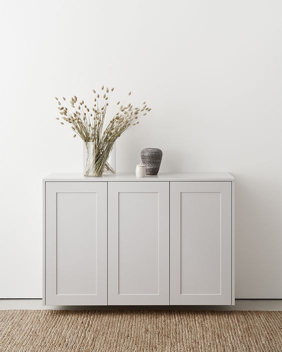 a pretty dove grey sideboard made of IKEA Metod cabinets, with pretty decor, is a cool and catchy idea