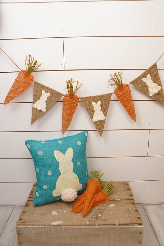 a rustic spring banner of carrots and burlap with bunny shapes is a cool decoration for spring and Easter