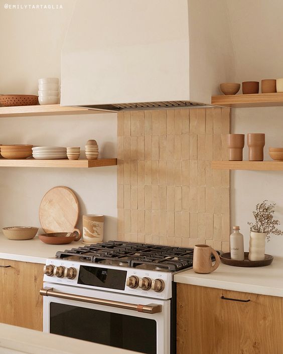 a serene kitchen with stainec abinets, white countertops, an unglazed terracotta tile backsplash and open shelves