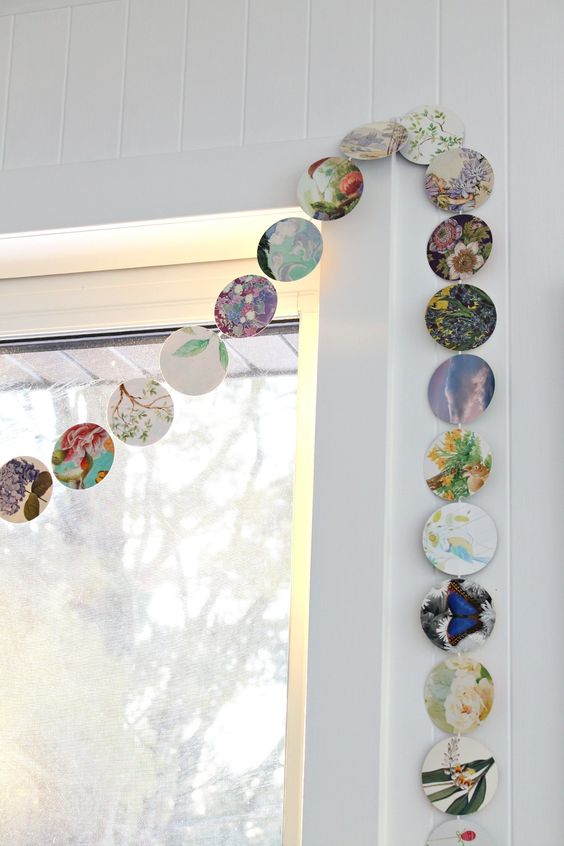 a simple floral garland made of upcycled old cards is a cool idea for decorating your space in spring and summer