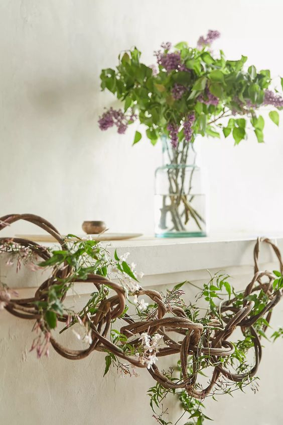 a spring agarland made of vine, greenery and blooms is a cool and natural decoration for indoors and outdoors