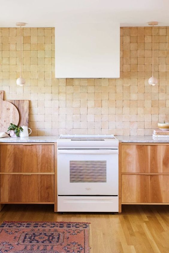 a stained kitchen with stone countertops, a terracotta tile backsplash and white appliances is a lovely space