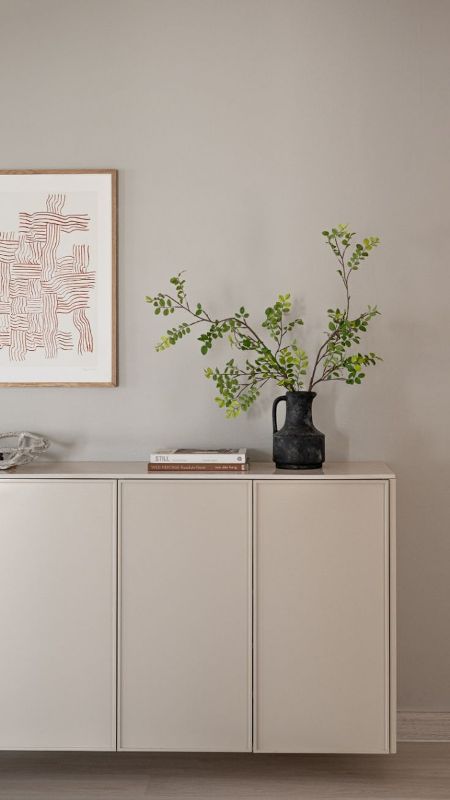an IKEA Metod console in a soft greige shade, with cool and catchy decor, is a very stylish idea to rock